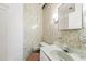 The bathroom is wallpapered and has a sink with faux marble surround and faucet at 9300 Gulf Blvd, St Pete Beach, FL 33706