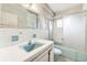 A vintage bathroom with blue fixtures, a tiled shower, and retro charm requiring refurbishment at 9300 Gulf Blvd, St Pete Beach, FL 33706