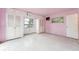 Bedroom featuring closets, windows, and light-pink painted walls and floor at 9300 Gulf Blvd, St Pete Beach, FL 33706