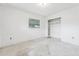 A bedroom with a window, closet with shelving, and a neutral palette needing refurbishment at 9300 Gulf Blvd, St Pete Beach, FL 33706