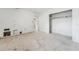 A bedroom showcasing a closet, view to an adjacent room and neutral palette needing refurbishment at 9300 Gulf Blvd, St Pete Beach, FL 33706