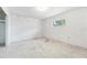 A bedroom featuring a window, neutral walls, and ample space ready for personalization needing refurbishment at 9300 Gulf Blvd, St Pete Beach, FL 33706