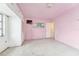 Bedroom featuring built-in closets, window, light-pink walls, and terrazzo floor at 9300 Gulf Blvd, St Pete Beach, FL 33706