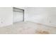 A bedroom with closet storage providing ample space, neutral palette needing refurbishment at 9300 Gulf Blvd, St Pete Beach, FL 33706