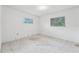 A spacious bedroom with two windows, a blank canvas ready for customization, needing refurbishment at 9300 Gulf Blvd, St Pete Beach, FL 33706