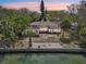 Waterfront single-story home featuring a private dock and concrete waterfront patio at 9300 Gulf Blvd, St Pete Beach, FL 33706