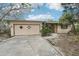 Modest single Gathering home featuring a garage and a front yard, set amidst lush, mature trees at 9300 Gulf Blvd, St Pete Beach, FL 33706