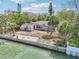 Single-story waterfront house with dock access and concrete patio at 9300 Gulf Blvd, St Pete Beach, FL 33706