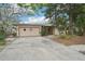 Charming single-story home with attached garage, large driveway and mature trees at 9300 Gulf Blvd, St Pete Beach, FL 33706