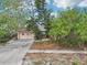 Home with a front exterior, featuring a garage, driveway, and partial landscaping at 9300 Gulf Blvd, St Pete Beach, FL 33706