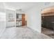 Empty room with kitchenette, wood walls and tiled floor at 9300 Gulf Blvd, St Pete Beach, FL 33706