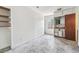 Empty room with kitchenette, wood walls and tiled floor at 9300 Gulf Blvd, St Pete Beach, FL 33706