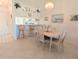 Cozy dining area with elegant chandelier, bar seating, and seamless transition to the kitchen at 967 Waterside Ln # 1, Bradenton, FL 34209