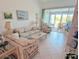 Bright living room with tile flooring, comfortable seating, and seamless access to the outdoor deck at 967 Waterside Ln # 1, Bradenton, FL 34209