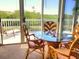 Bright sunroom with glass table, seating, and a view of the outdoors at 967 Waterside Ln # 1, Bradenton, FL 34209