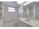 Bright bathroom featuring a bathtub, vanity, and large mirror at 1026 Graham Rd, Venice, FL 34293