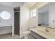 Bathroom with shower, toilet, vanity, and unique round window offering natural light at 1026 Graham Rd, Venice, FL 34293