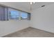 Bright bedroom featuring a large window with natural light and neutral color scheme at 1026 Graham Rd, Venice, FL 34293