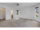 Bright bedroom featuring white walls and carpet, leading to an ensuite bathroom and walk-in closet at 1026 Graham Rd, Venice, FL 34293