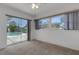 Bright bedroom with sliding glass door and large window, offering plenty of natural light and pool view at 1026 Graham Rd, Venice, FL 34293
