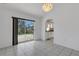 Dining area with tile floors and sliding glass doors leading to a screened-in patio at 1026 Graham Rd, Venice, FL 34293