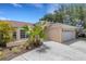 Charming home exterior with a well-manicured lawn and attached garage at 1026 Graham Rd, Venice, FL 34293