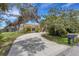 Charming single-Gathering home with mature trees, manicured landscaping, and a curving driveway at 1026 Graham Rd, Venice, FL 34293