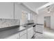 Sunlit kitchen with white cabinets and stainless steel appliances at 1026 Graham Rd, Venice, FL 34293