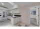 Bright kitchen boasting ample counter space, streamlined white cabinetry, and unique decorative wall paper at 1026 Graham Rd, Venice, FL 34293