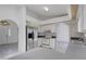 Bright kitchen with stainless steel refrigerator and white cabinets, offering ample storage and countertop space at 1026 Graham Rd, Venice, FL 34293