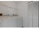 Laundry room featuring a side-by-side washer and dryer and a shelved closet at 1026 Graham Rd, Venice, FL 34293