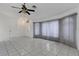 Bright living room featuring tile floors, bay windows, and an arched entryway to the foyer at 1026 Graham Rd, Venice, FL 34293