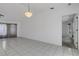 Bright living room with tiled floor, neutral walls and chandelier lighting at 1026 Graham Rd, Venice, FL 34293