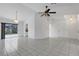 Open-concept living room with tile floors and access to the kitchen and screened-in patio at 1026 Graham Rd, Venice, FL 34293