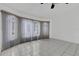 Bright living room with bay windows, tile floors, a ceiling fan, and neutral paint at 1026 Graham Rd, Venice, FL 34293