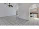 Open-concept living room with tile floors and arched entryway to the kitchen and dining area at 1026 Graham Rd, Venice, FL 34293