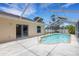 Outdoor pool enclosed with screen, connected to a sliding glass door to the home's interior at 1026 Graham Rd, Venice, FL 34293
