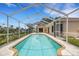Sparkling pool with screened enclosure for year-round enjoyment at 1026 Graham Rd, Venice, FL 34293