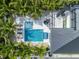 Aerial view of a stunning home with a pool, lounging areas, lush landscaping, and outdoor amenities for luxurious living at 128 Fillmore Dr, Sarasota, FL 34236