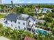 Aerial view of the backyard featuring a modern three-story white home with a pool, and spiral staircase at 128 Fillmore Dr, Sarasota, FL 34236