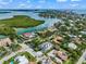 Stunning aerial view of luxury waterfront homes with lush landscaping and private boat docks along the scenic coastline at 128 Fillmore Dr, Sarasota, FL 34236