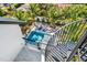 Aerial view of a modern pool and lounge area, accessible by a striking spiral staircase at 128 Fillmore Dr, Sarasota, FL 34236