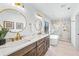 Bright bathroom with double vanity, modern fixtures, soaking tub, and marble shower at 128 Fillmore Dr, Sarasota, FL 34236