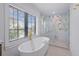 Stylish bathroom featuring a soaking tub, walk-in shower with glass door, and modern fixtures at 128 Fillmore Dr, Sarasota, FL 34236