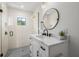 Bright bathroom with a modern vanity, glass-enclosed shower, stylish fixtures, and ample natural light at 128 Fillmore Dr, Sarasota, FL 34236
