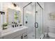 Bathroom featuring glass enclosed shower, modern wallpaper, and quartz counters at 128 Fillmore Dr, Sarasota, FL 34236