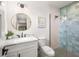 Bright bathroom featuring modern fixtures, glass enclosed shower, and stylish blue tile at 128 Fillmore Dr, Sarasota, FL 34236