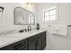 Modern bathroom with black vanity, marble countertop, and black fixtures at 128 Fillmore Dr, Sarasota, FL 34236