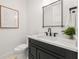 Powder room featuring a modern black vanity, black fixtures, and artwork at 128 Fillmore Dr, Sarasota, FL 34236
