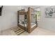 bedroom with wooden bunk beds, lots of natural light, and modern decor at 128 Fillmore Dr, Sarasota, FL 34236